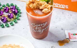 A Bloody Mardi with a Tabasco salt rim and a skewer of Popeye's chicken strips
