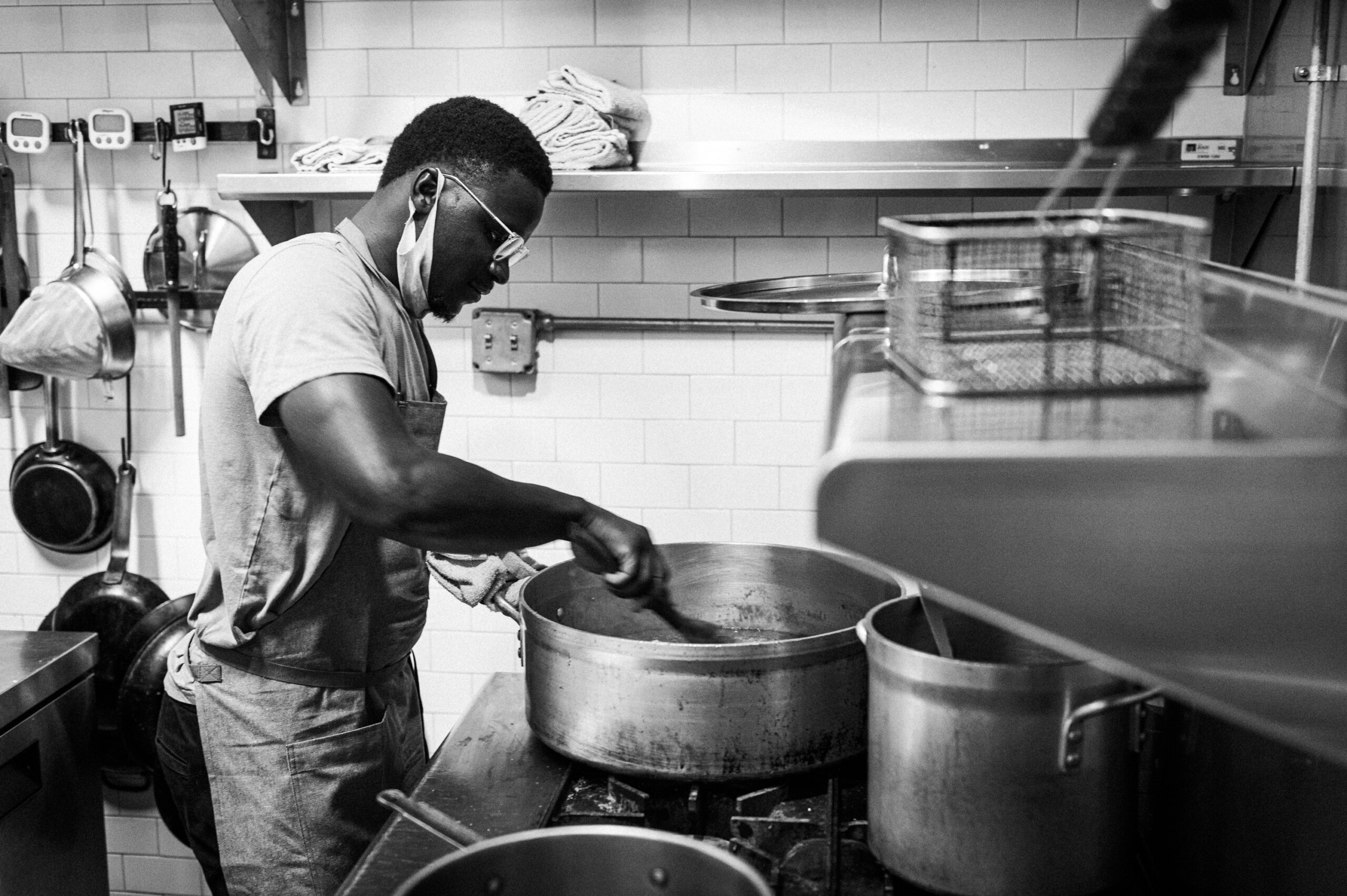 Chef Serigne Mbaye stirs a pot