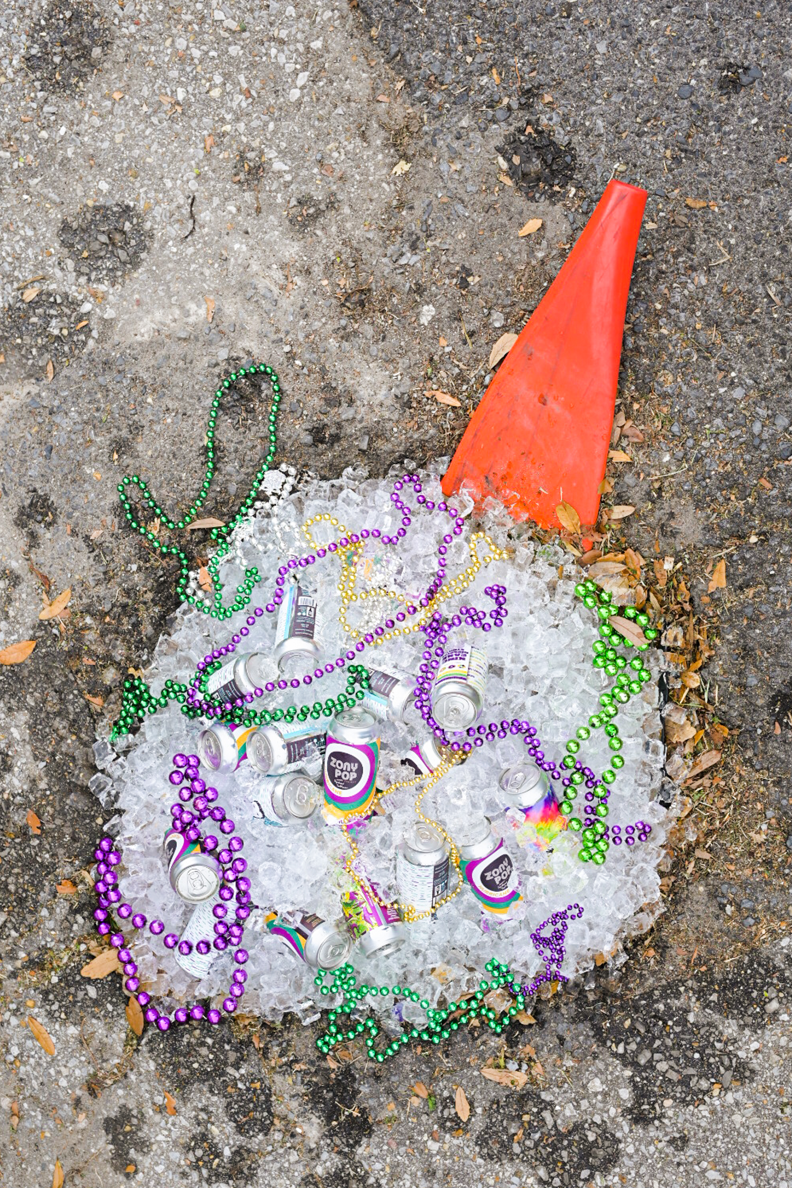 A New Orleans pothole filled with ice, beer, and Mardi Gras beads