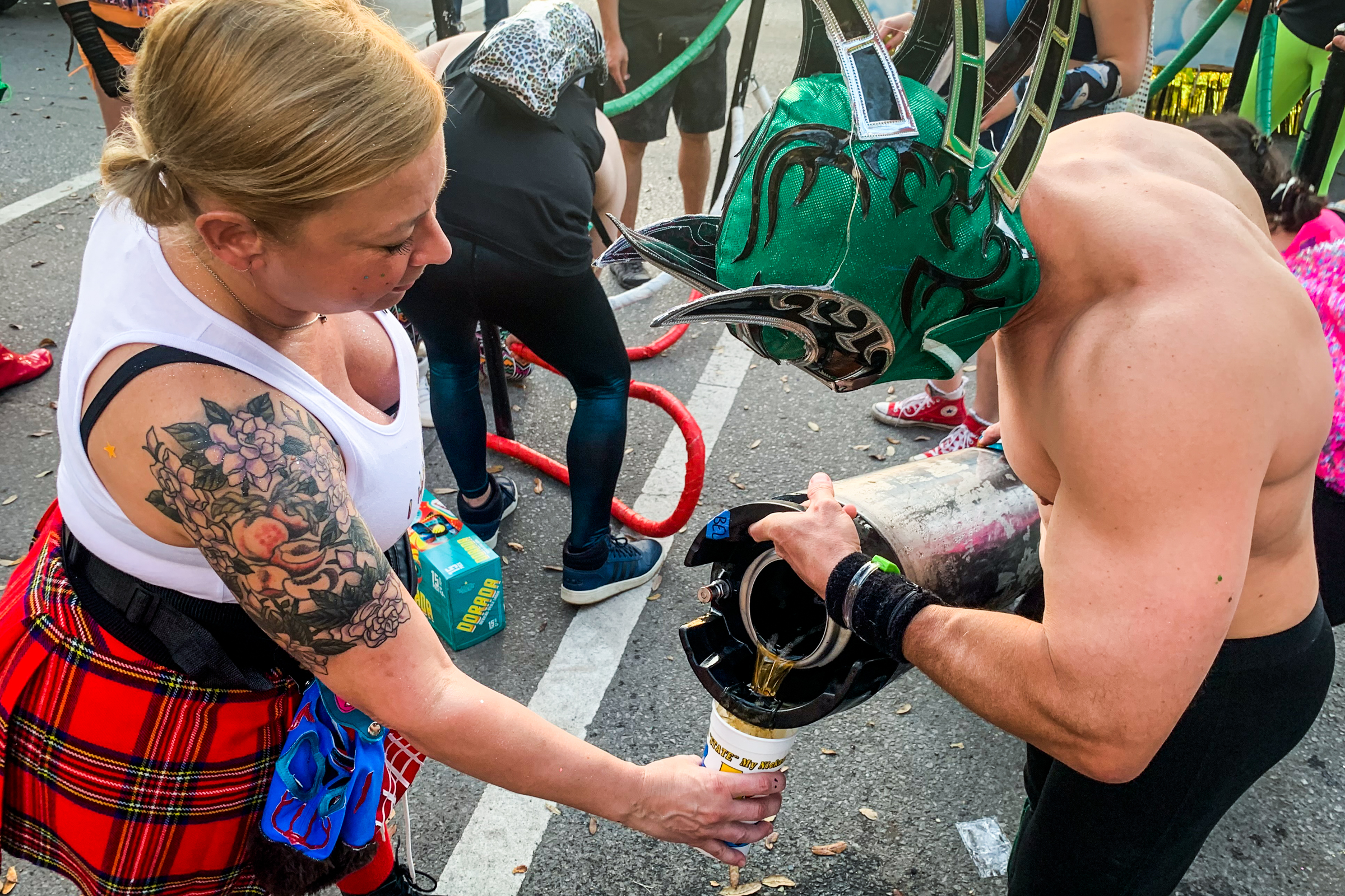 Lucha Krewe members fuel up with beer before marching
