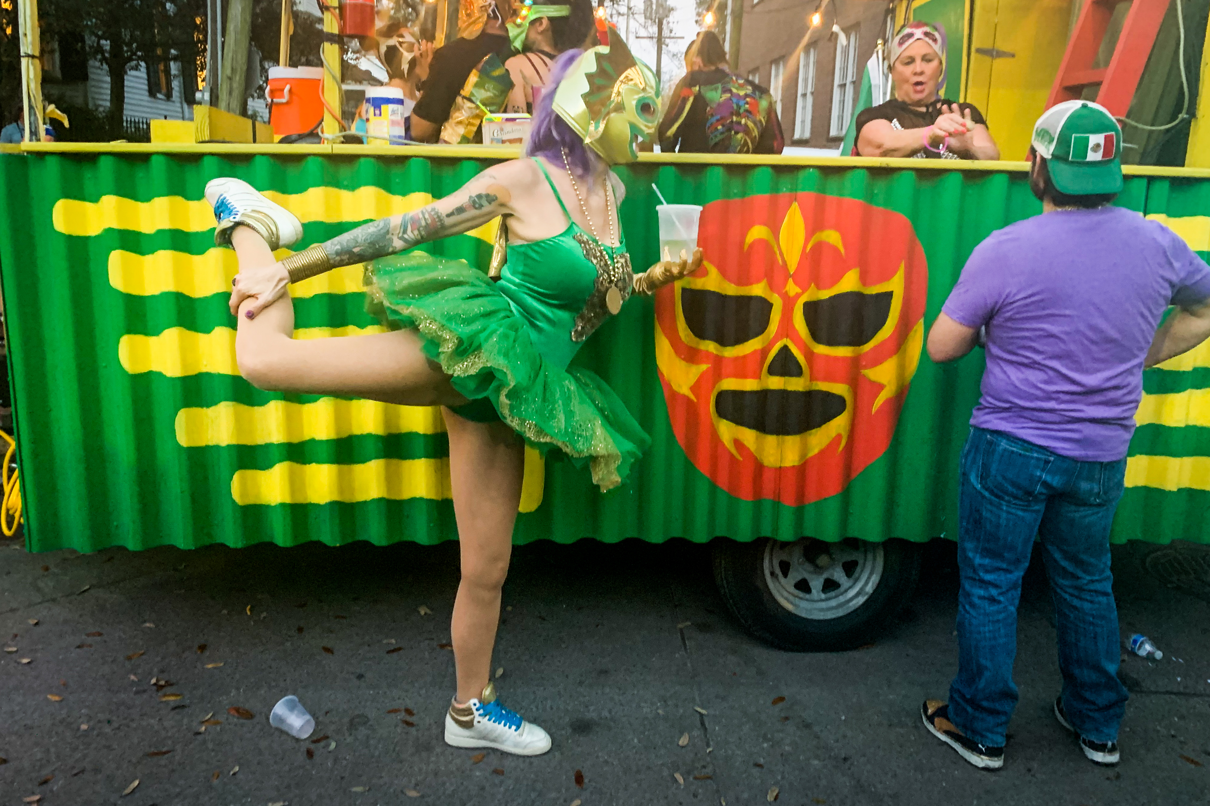 Meghan, a member of Lucha Krewe, stretches before the parade