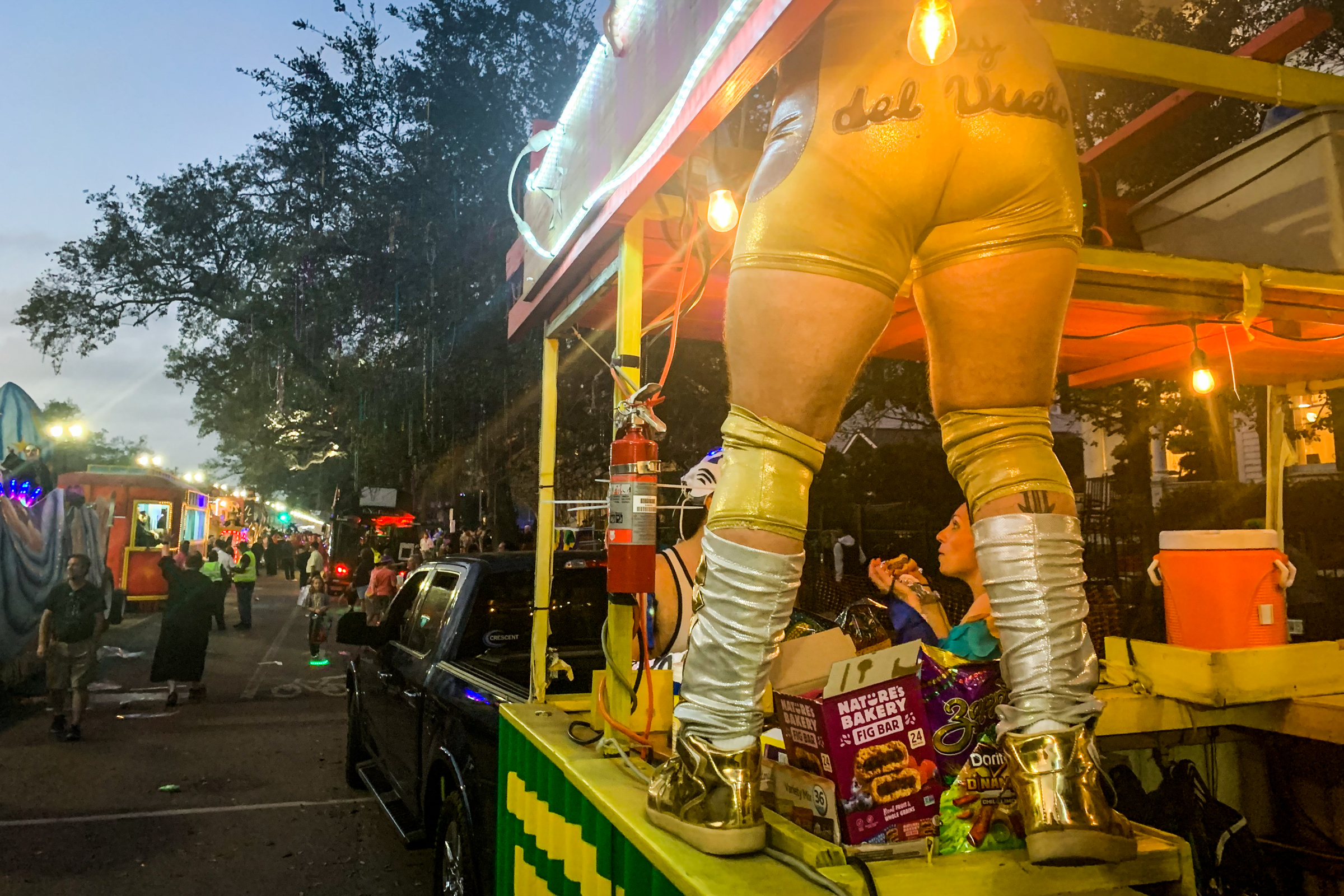 A member of Lucha Krewe stands on the trailer along the parade route