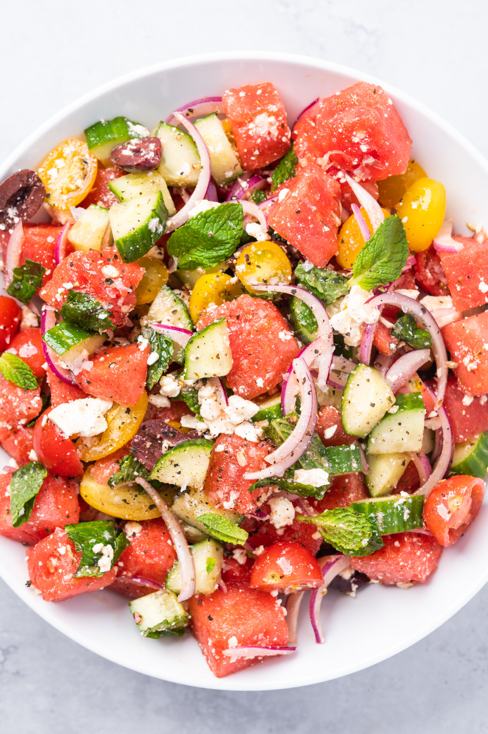 Greek-inspired salad with watermelon, cucumber, tomatoes, red onion, and feta