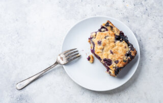 First bite out of a freshly-baked blueberry pie bar