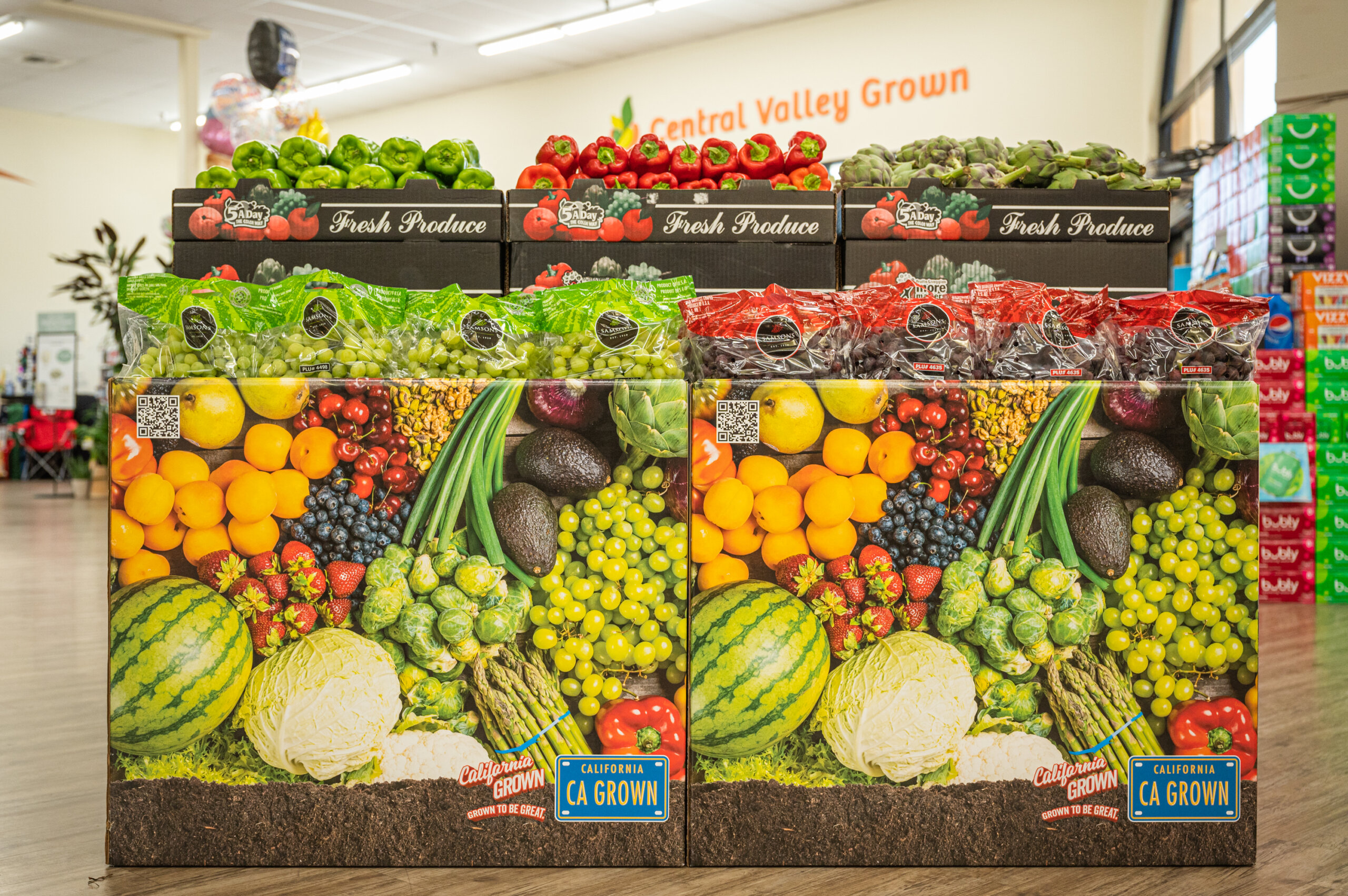 Grocery store produce bins labeled with the California GROWN logo