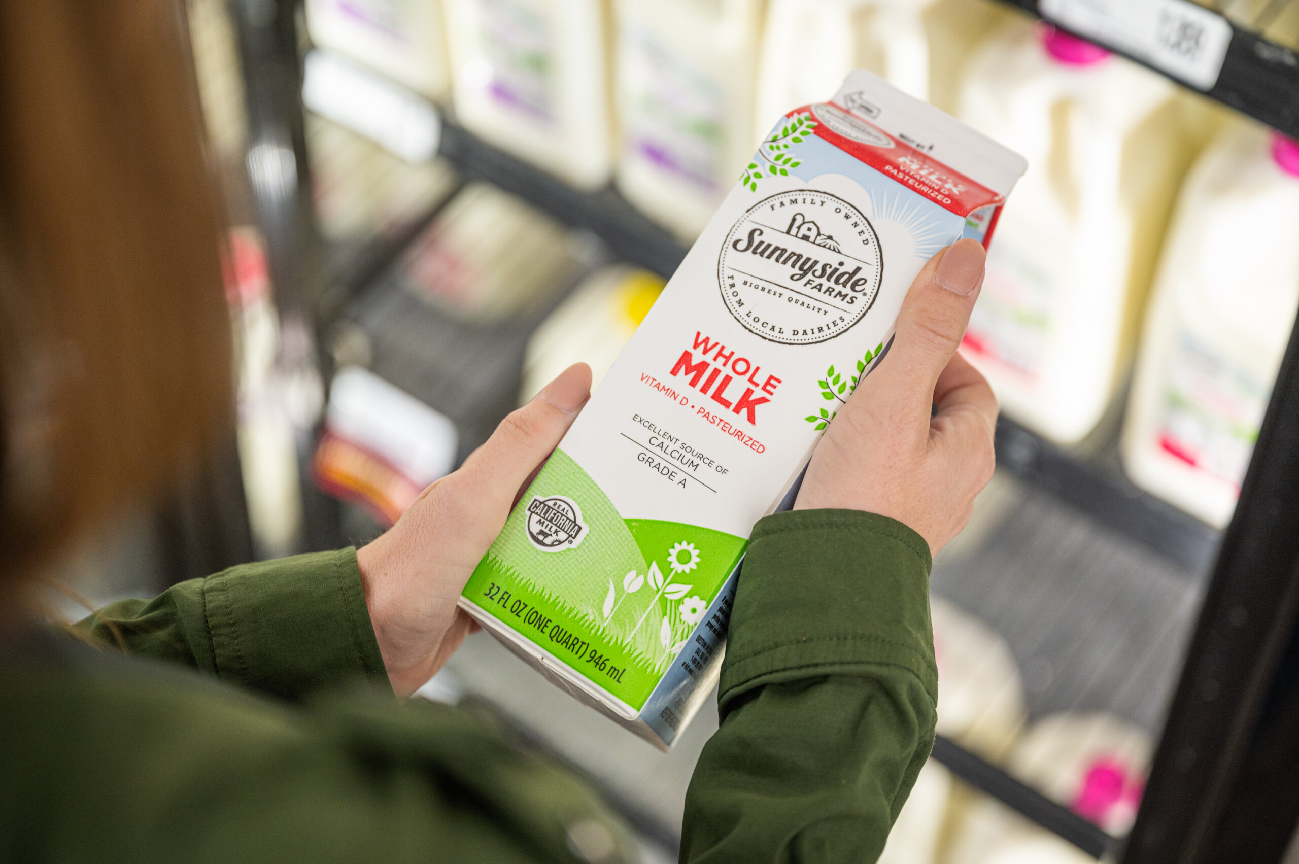 A customer inspects the Real California Milk label on a carton of milk