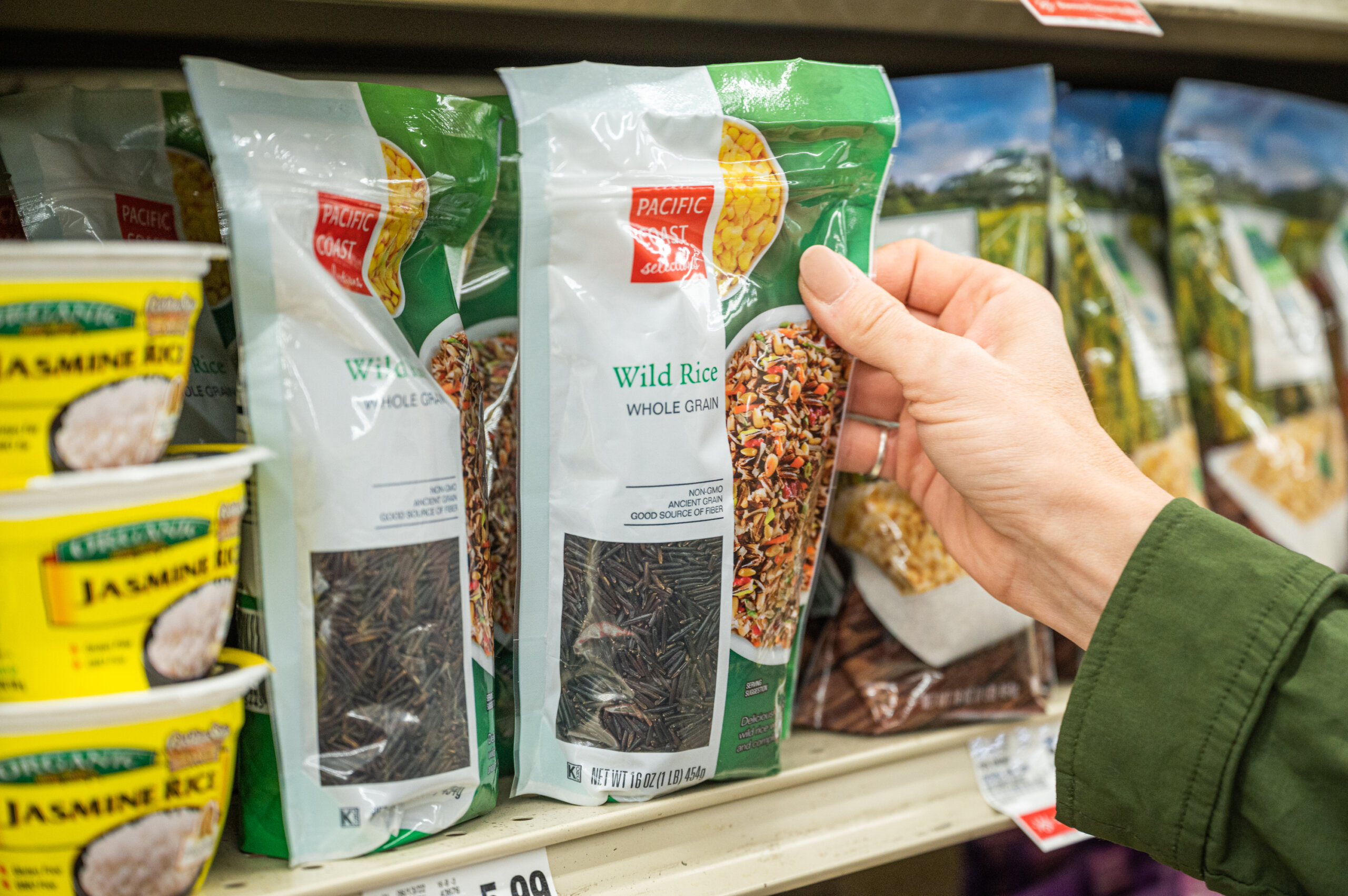 A grocery store customer picks out a bag of California-grown wild rice