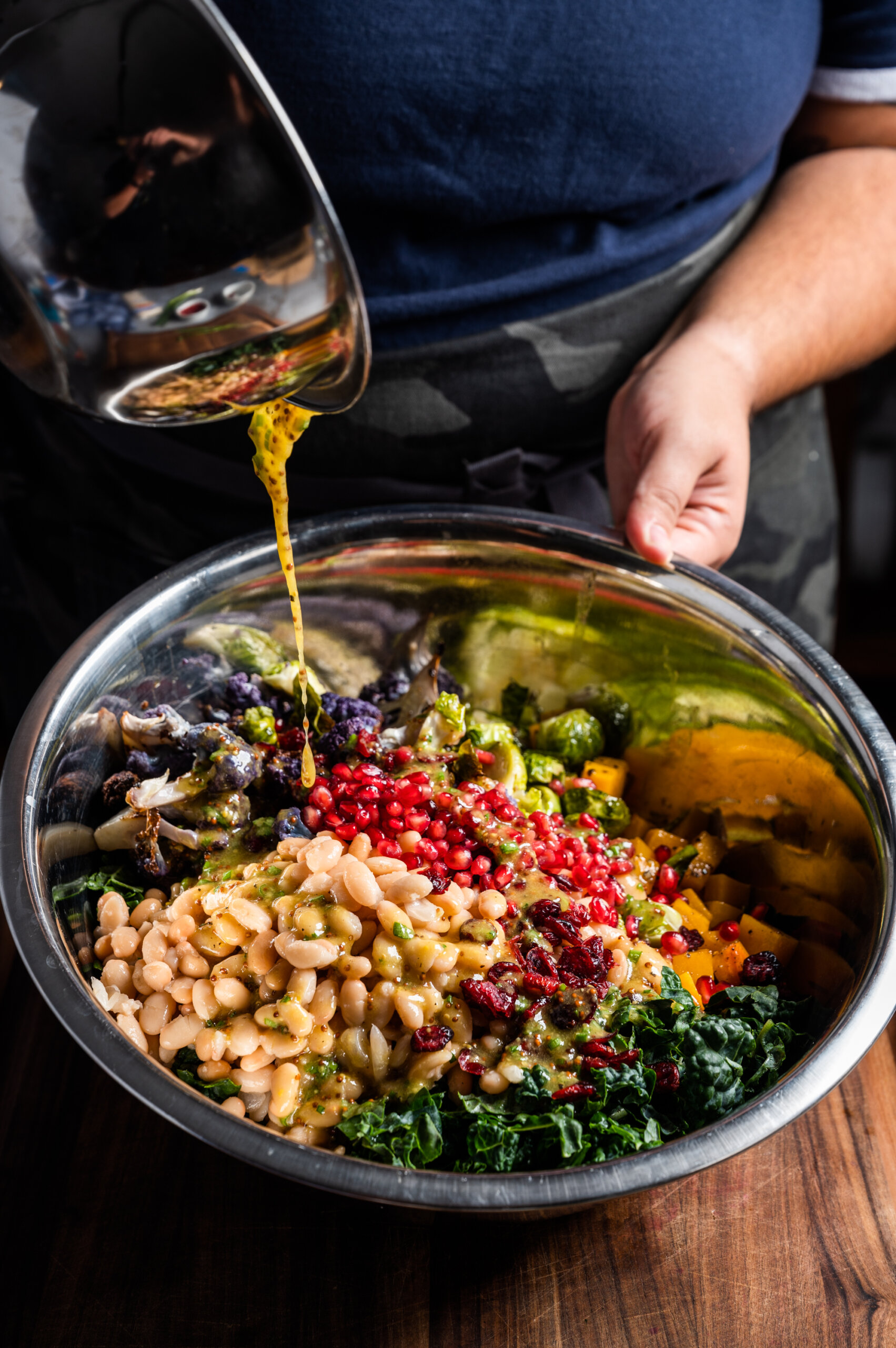 A vinaigrette is poured over all the salad ingredients