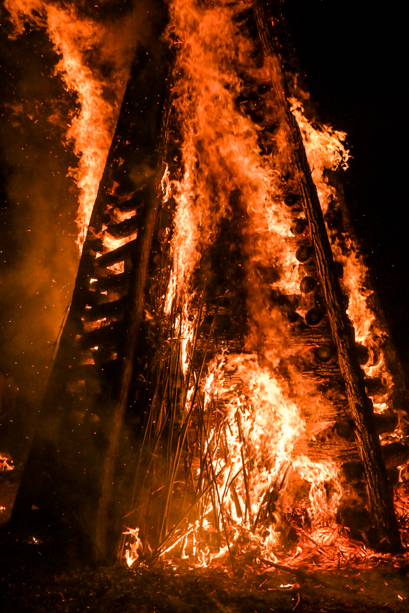 A 15-foot tower burns as part of a Christmas Eve tradition