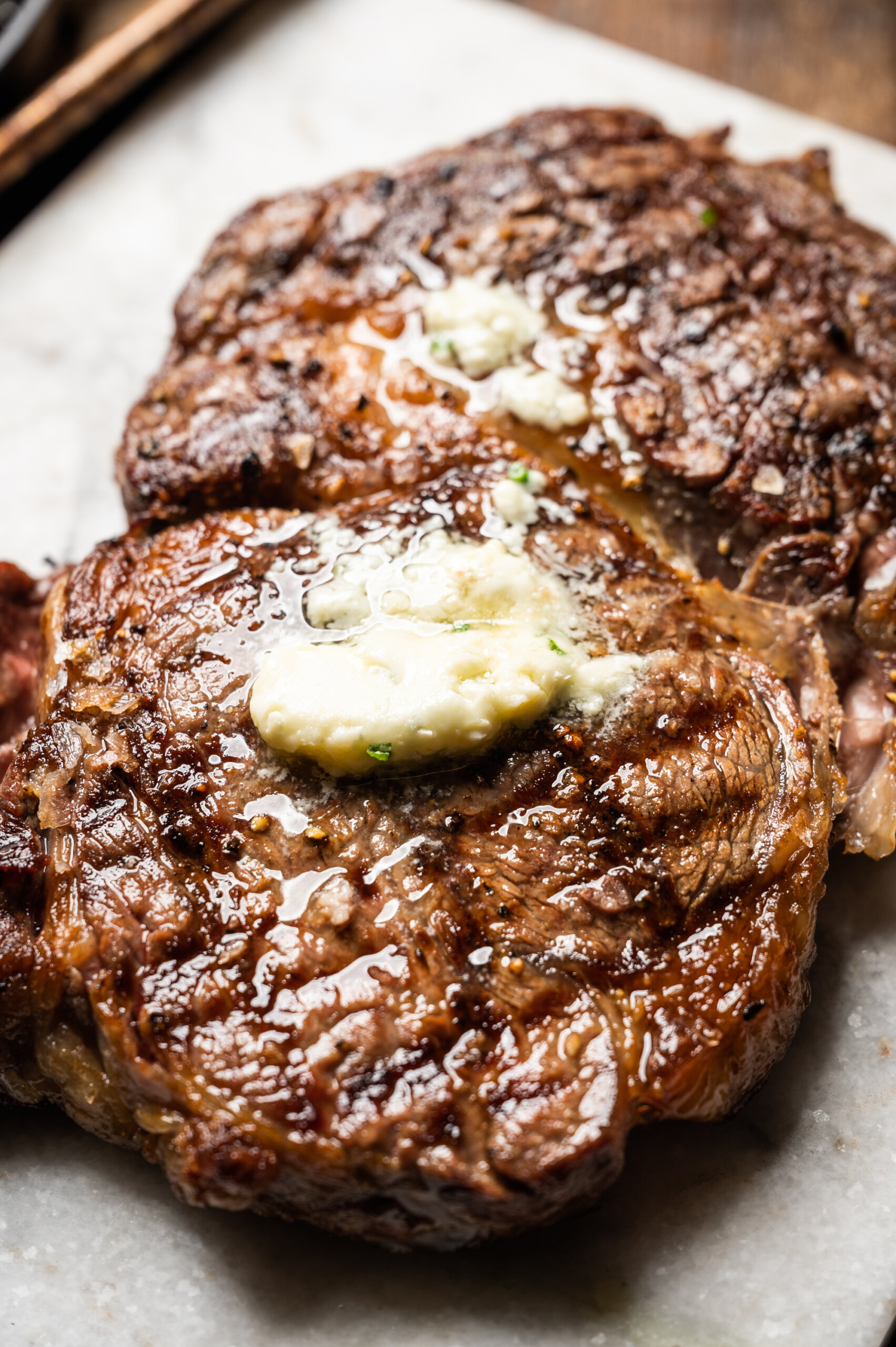 Grilled ribeye steak with melted bleu cheese butter