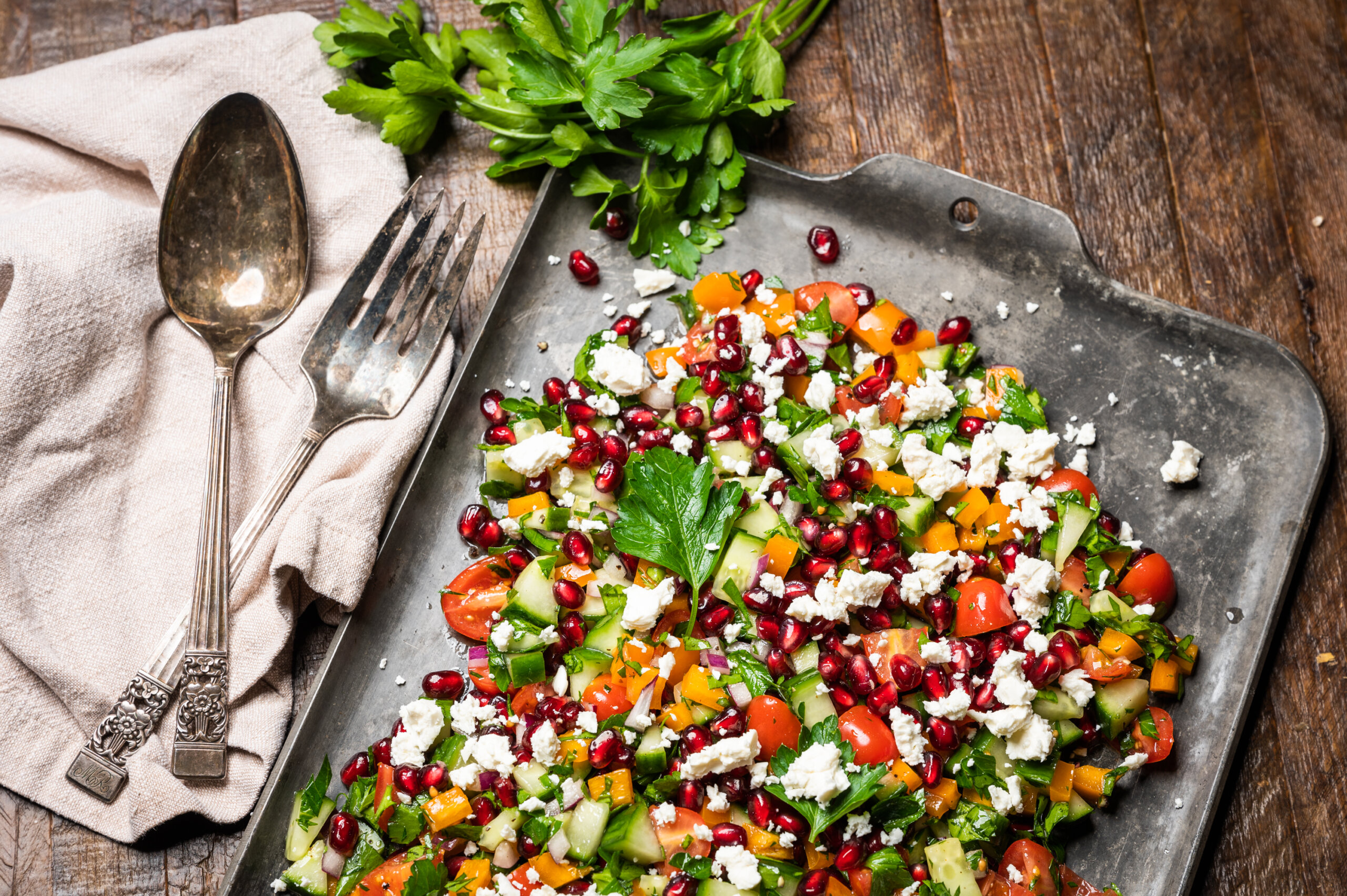 Aliza Sokolow's recipe for Israeli Salad with cucumber, bell pepper, parsley, red onion, and pomegranate arils.