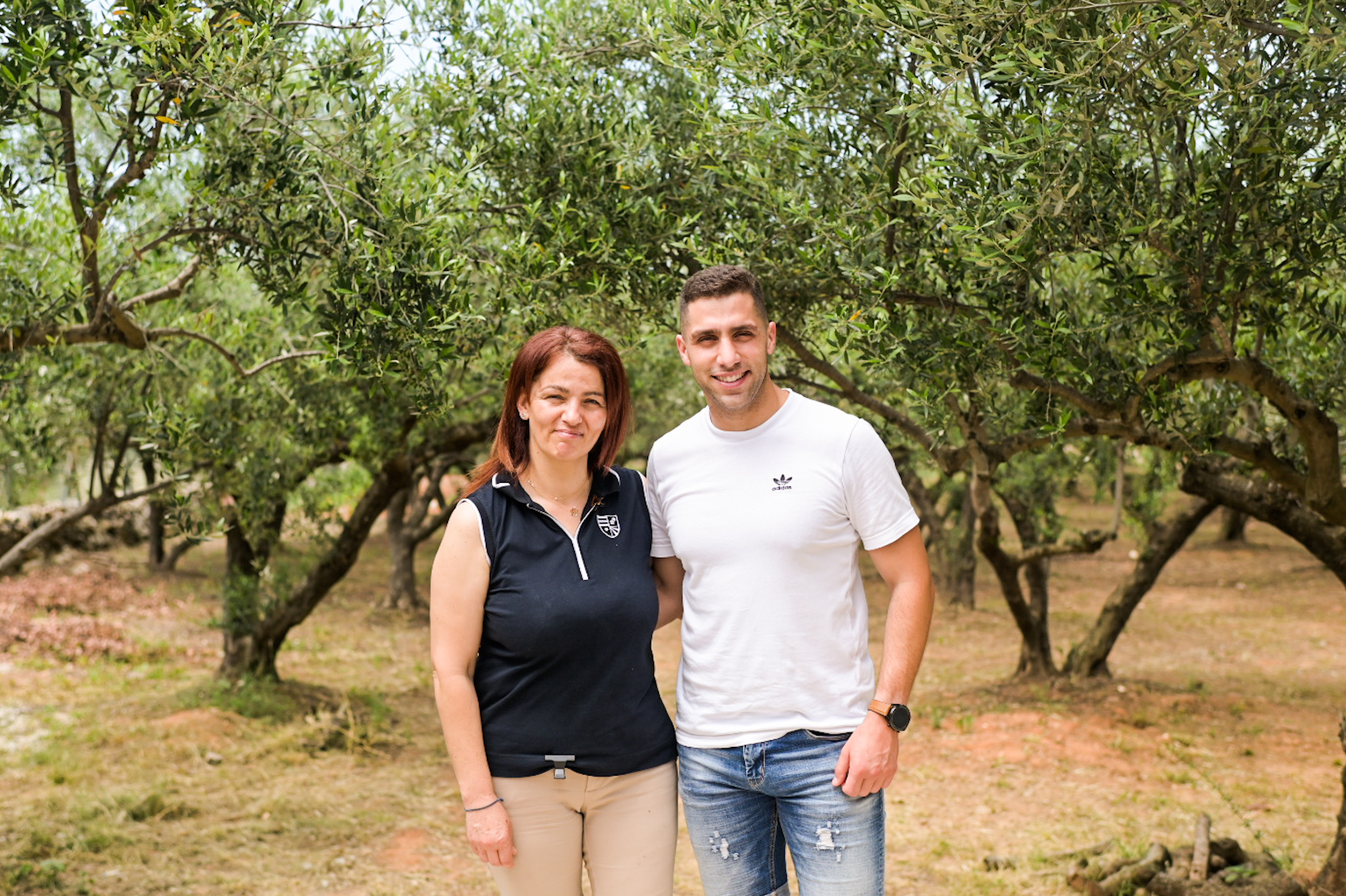 Veerna with her son, in front of her brother's olive trees