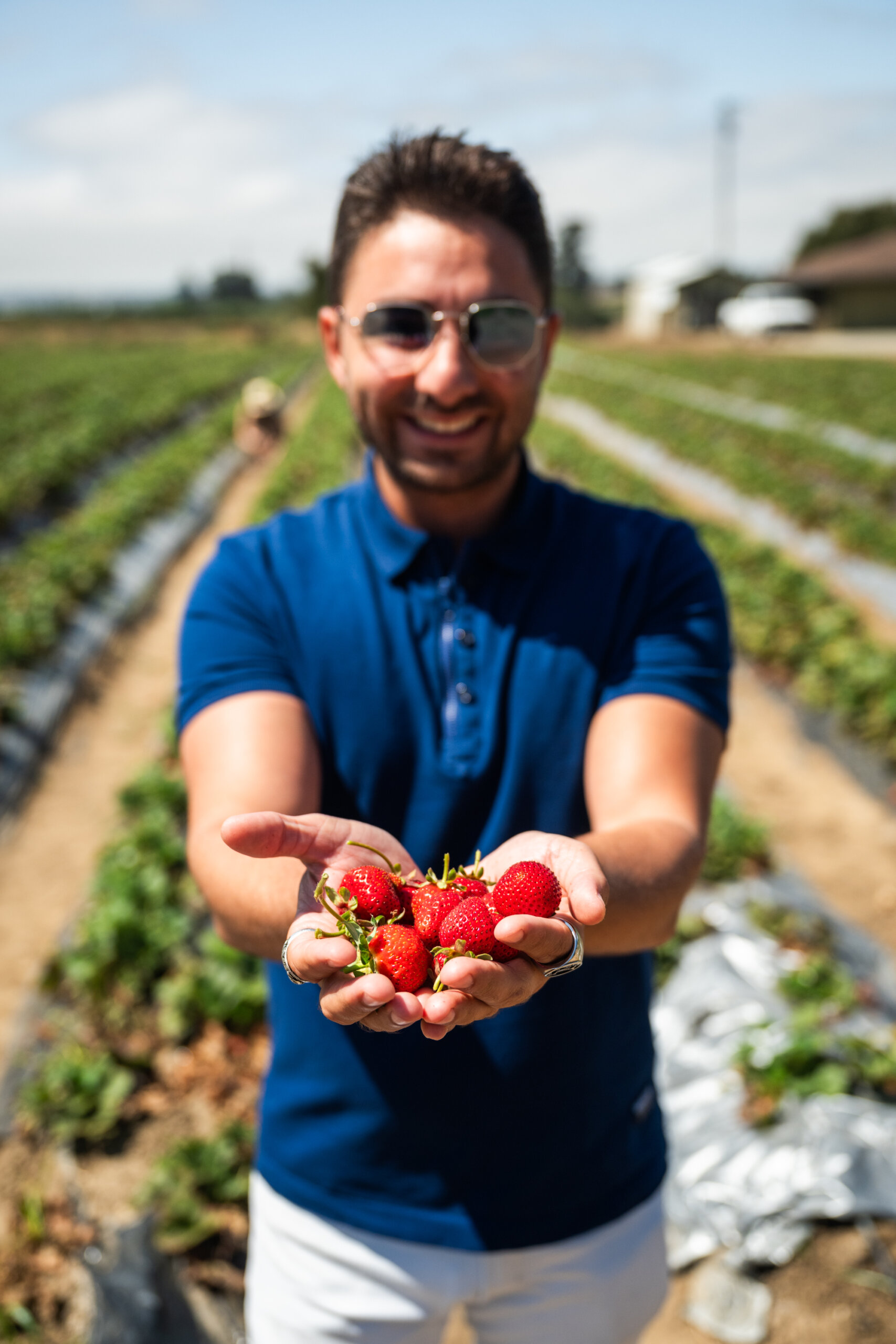 A delegate holds out a handful of fresh-picked berries