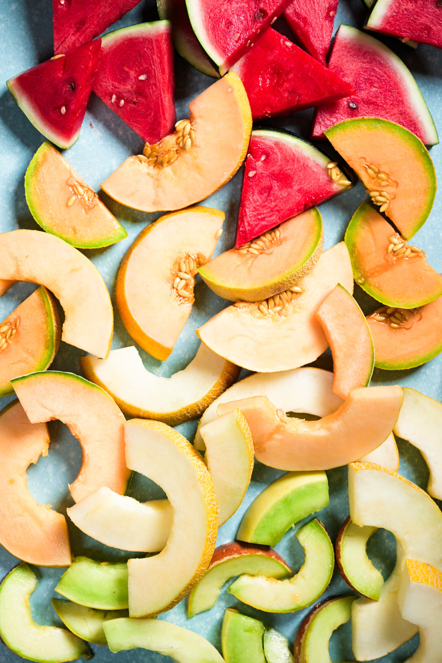 Slices of colorful melons create a vibrant summer gradient