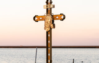 A metal cross with a carving of Jesus' face off the coast of Shell Beach, Louisiana