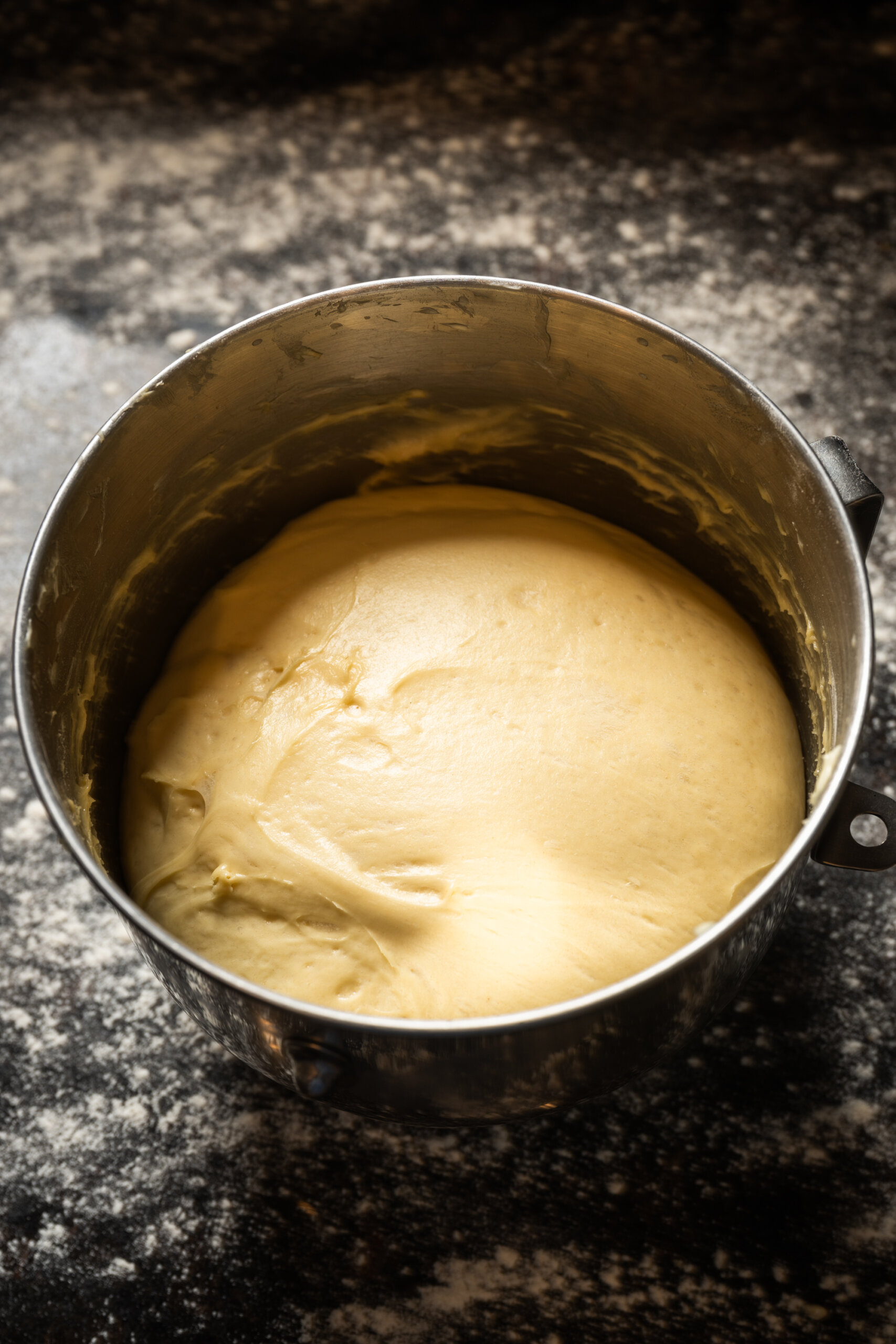 Yeasted dough rising in a mixer bowl for king cake