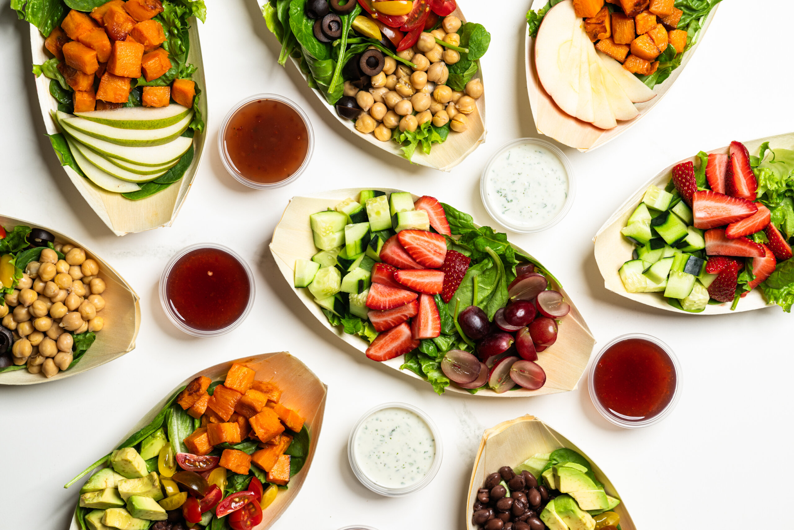 Table top spread of individual portioned salads featuring California-grown produce
