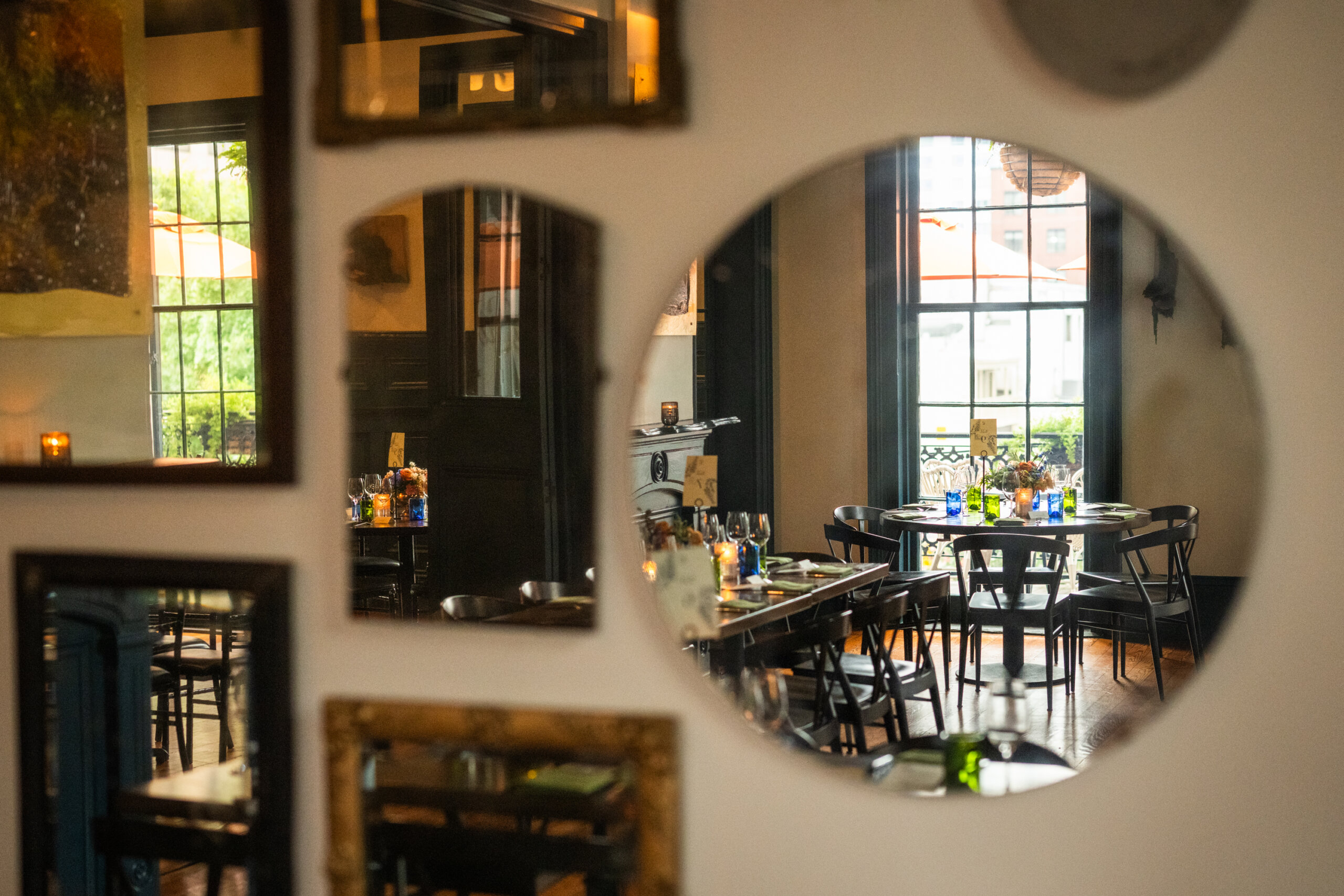 Details of a table setting reflected in a wall of mirrors in the upstairs dining room