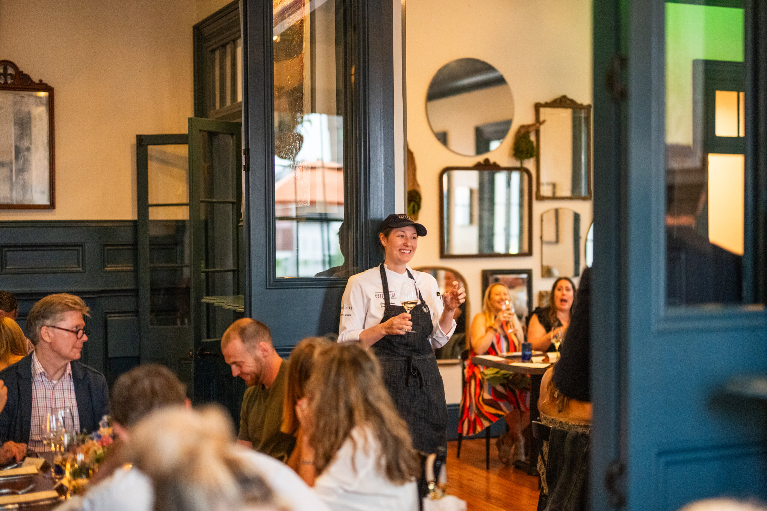 Chef Amy Mehrtens of Copper Vine speaks to dinner guests