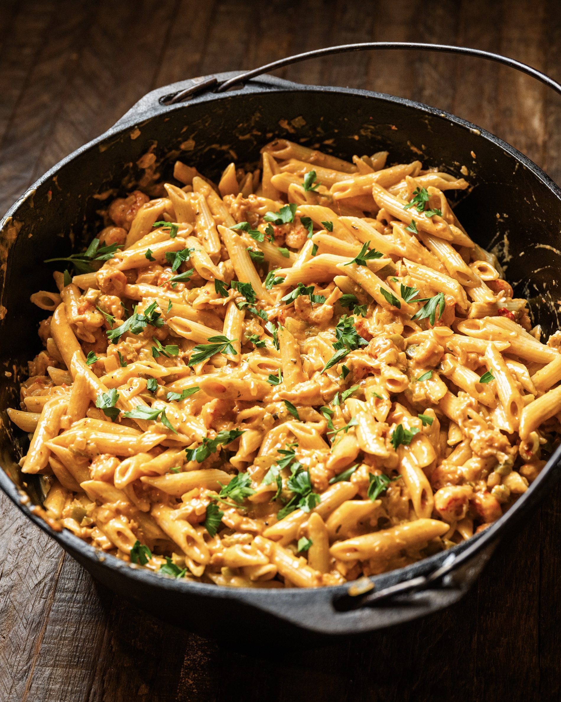 A large cast iron Dutch oven filled with creamy crawfish pasta