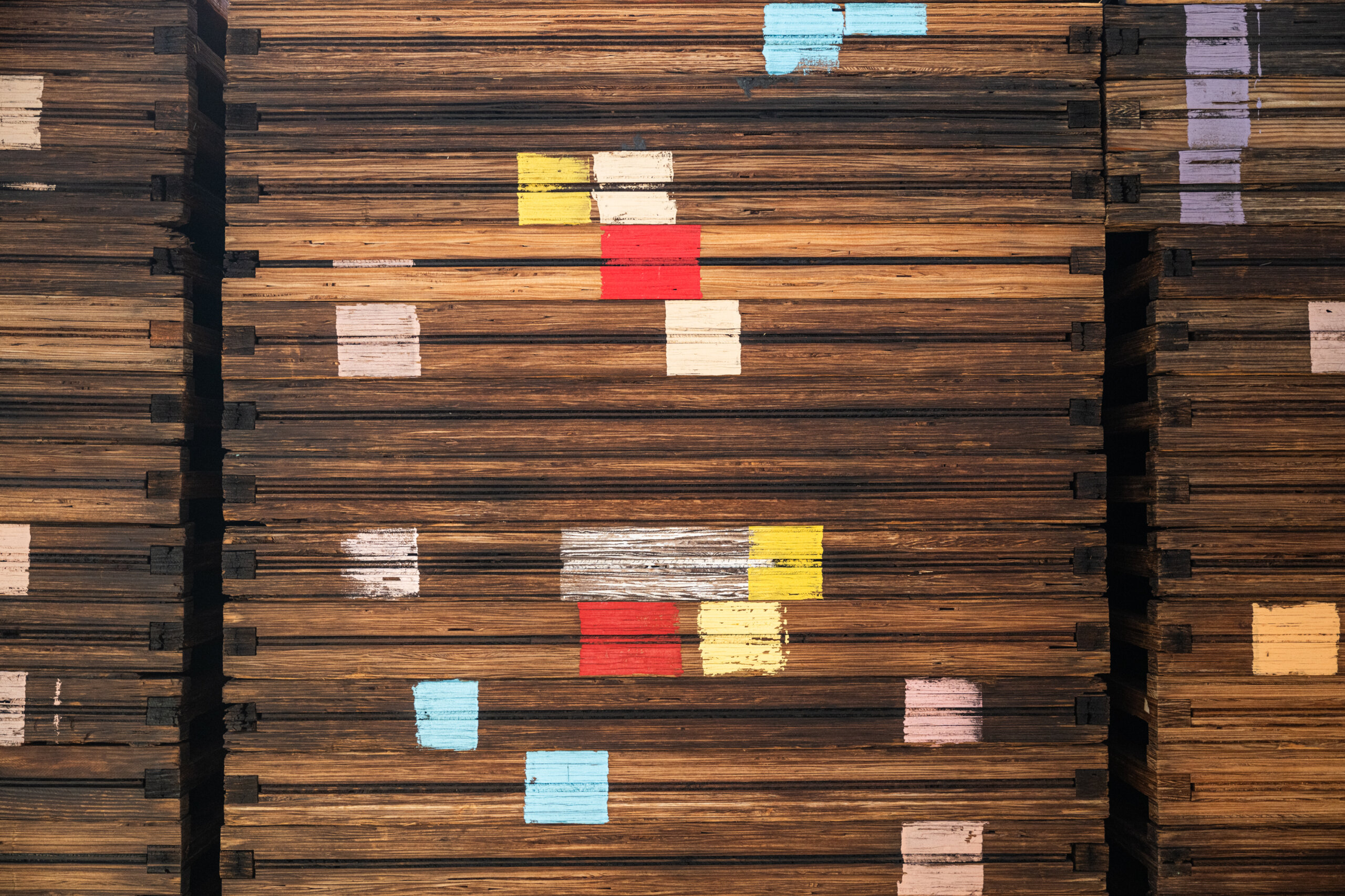 Paint markings on a stack of wooden fruit drying trays