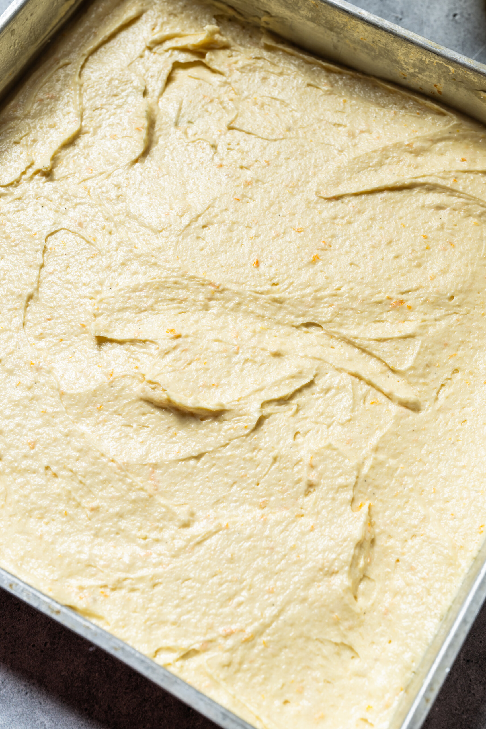 An even later of batter spread in the pan, ready for baking