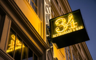 An exterior sign welcomes you to 34 Restaurant & Bar in New Orleans