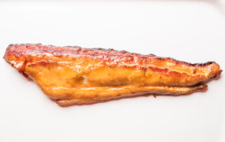 A smoked fillet of mackerel displayed against a white background.