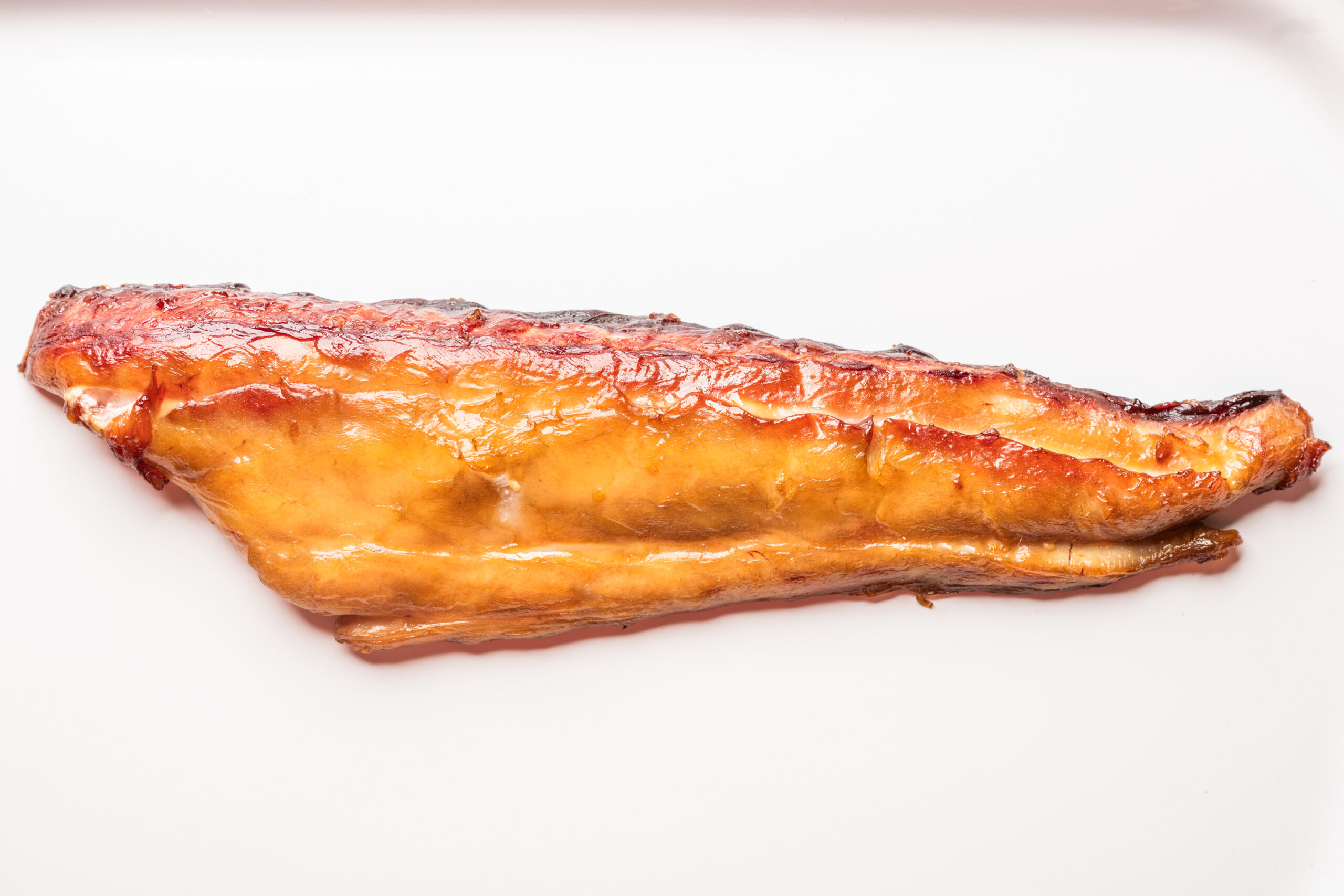 A smoked fillet of mackerel displayed against a white background.